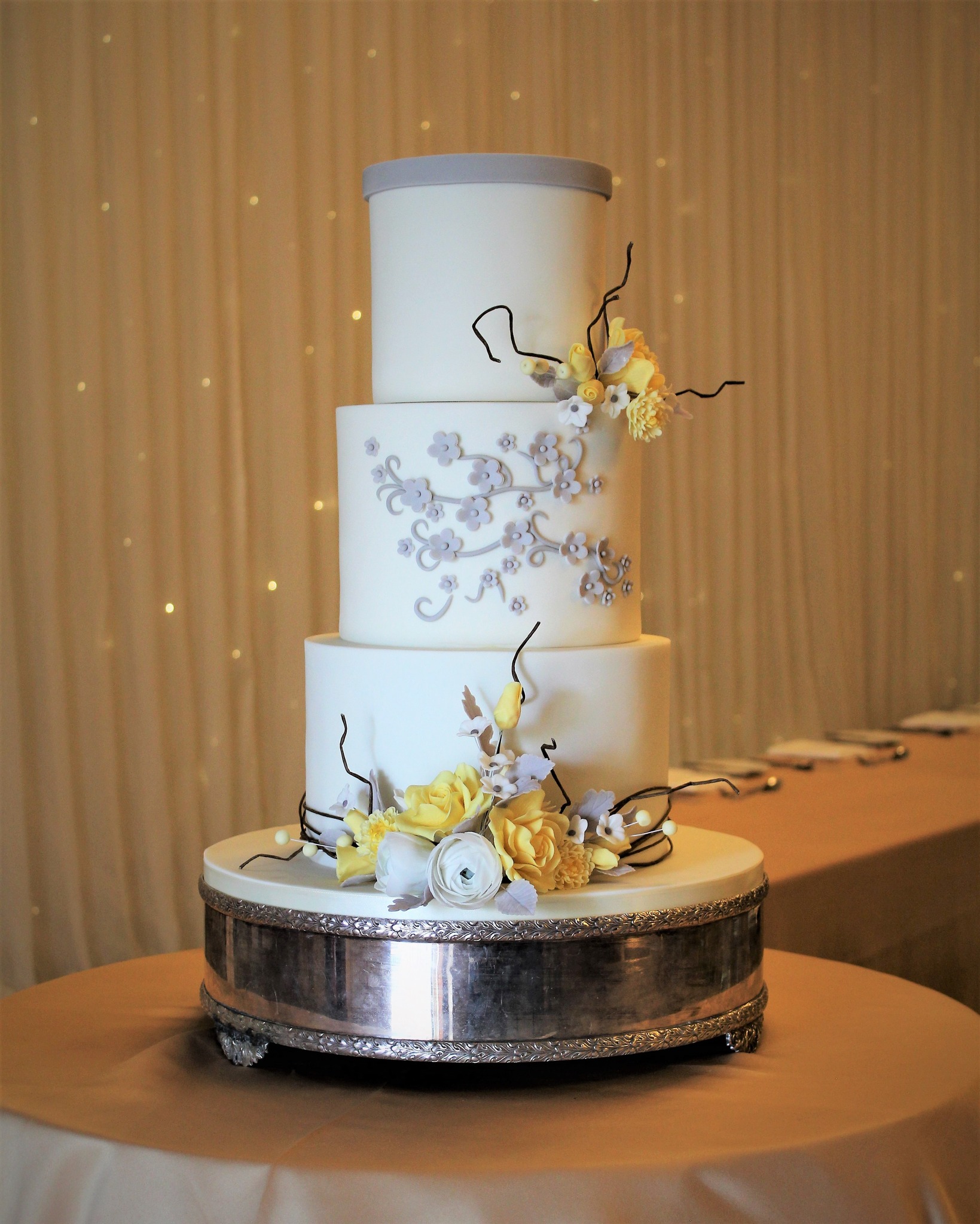 A lovely colour combination … white and yellow to co-ordinate with the bride … a hint of
                    grey … a reference to the groom’s attire.