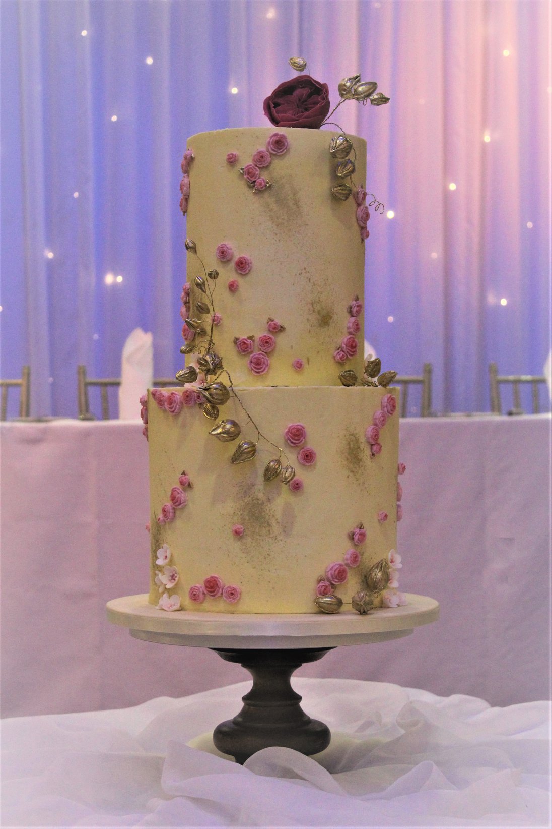 A very pretty and whimsical wedding cake studded with roses to reflect the bride's bouquet.